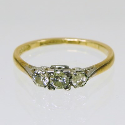 Lot 305 - An 18 carat gold three stone diamond ring, 2g,...