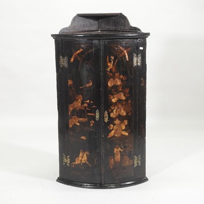 Lot 311 - A George III black japanned bow front hanging corner cupboard