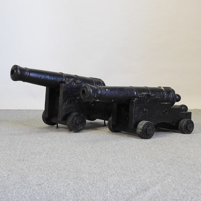 Lot 387 - A near pair of black painted decorative cannons