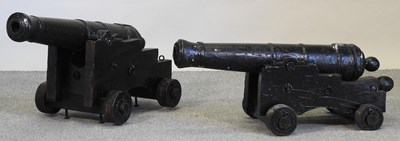 Lot 387 - A near pair of black painted decorative cannons