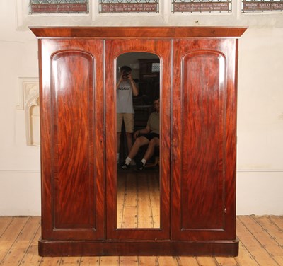 Lot 747 - A Victorian mahogany triple wardrobe, having a...