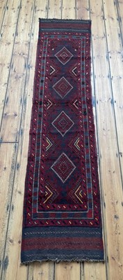 Lot 566 - A Meshwani runner, on a red ground