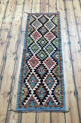 Lot 596 - A Chobi kilim runner rug, of colourful...