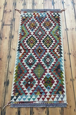 Lot 845 - A Chobi kilim runner rug, of colourful...