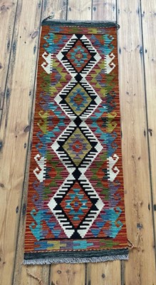 Lot 839 - A Chobi kilim runner rug, of colourful...