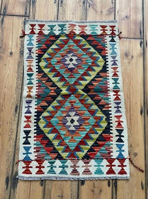 Lot 633 - A Chobi kilim rug, of colourful geometric design