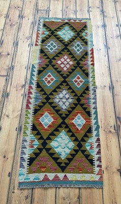 Lot 498 - A Maimana kilim runner rug, on a colourful...