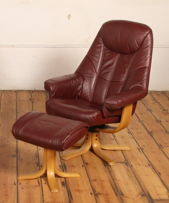 Lot 542 - A burgundy leather swivel armchair with...