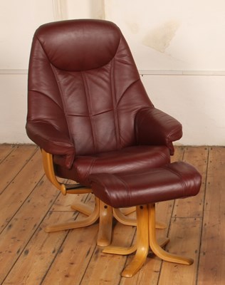 Lot 543 - A burgundy leather swivel armchair with...