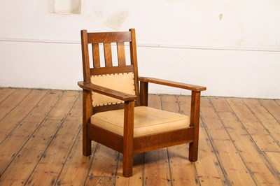 Lot 18 - An Arts & Crafts Mission style oak armchair,...