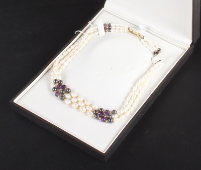 Lot 429 - A three-strand natural freshwater pearl...