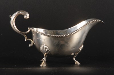 Lot 136 - A George V silver gravy boat, of helmet shape,...