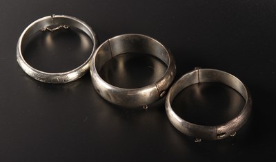 Lot 97 - Three silver bangles, each engraved with...
