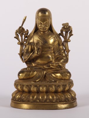 Lot 89 - A Chinese gilt bronze figure of a deity, shown...