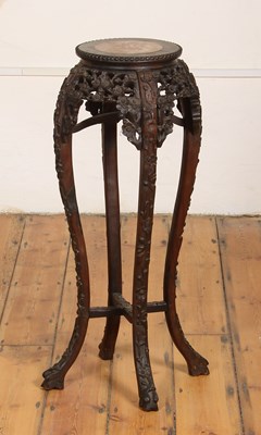 Lot 416 - A Chinese carved wood marble top jardiniere stand