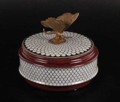 Lot 501 - A porcelain trinket box, surmounted by a...