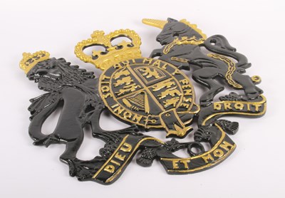 Lot 257 - A black and gilt painted cast metal coat of...