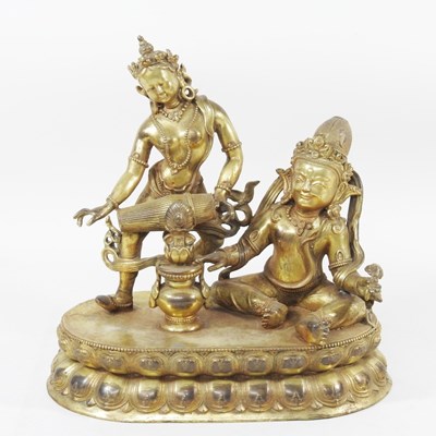 Lot 531 - Tibetan school, seated figures, gilt bronze,...