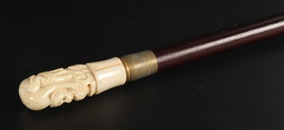 Lot 312 - A carved bone handled walking stick