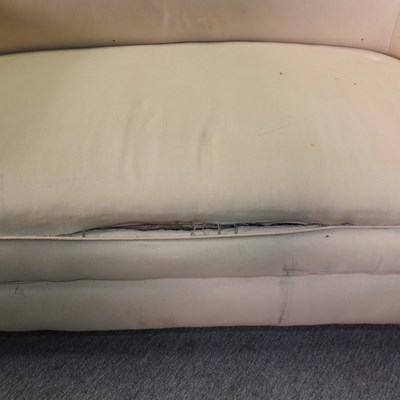 Lot 88 - An early 20th century cream upholstered chesterfield sofa
