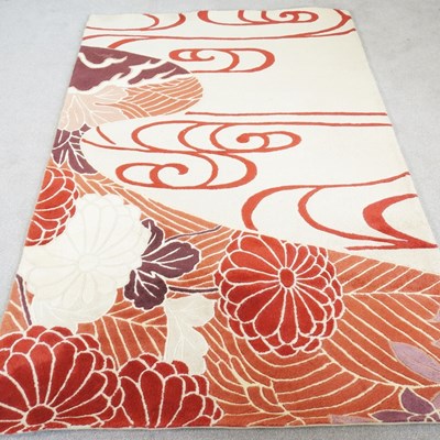 Lot 333 - A modern woollen rug, with red flowers and...
