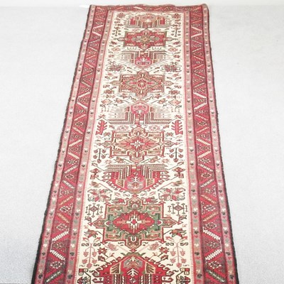 Lot 279 - A Persian heriz runner, with a central row of...