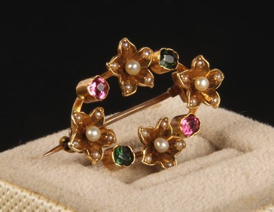 Lot 440 - A yellow metal seed pearl and gem set flower...