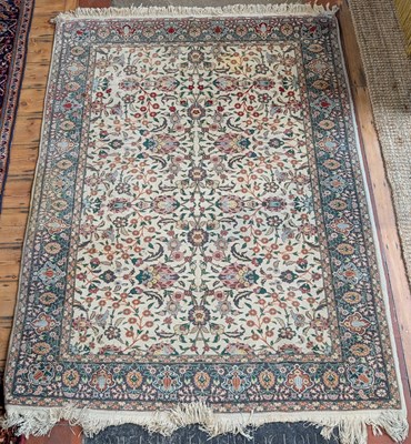 Lot 811 - A Persian woollen rug, decorated with flowers...