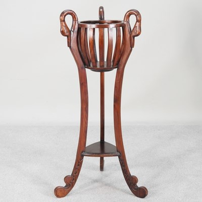 Lot 633 - A modern hardwood plant stand, carved with...