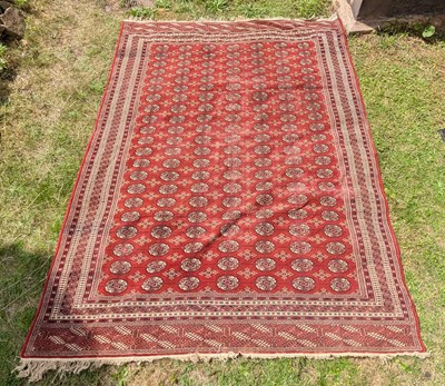 Lot 575 - A large Bokhara rug, on a red ground