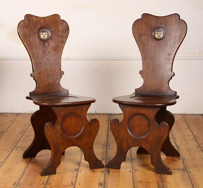 Lot 34 - A pair of George III oak hall chairs, each...