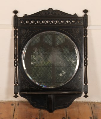 Lot 657 - A Victorian ebonised wall mirror, having a...