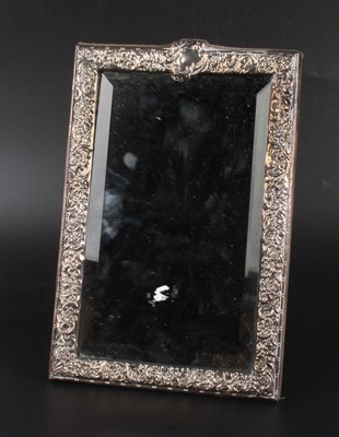 Lot 68 - A silver framed mirror, repousse decorated...