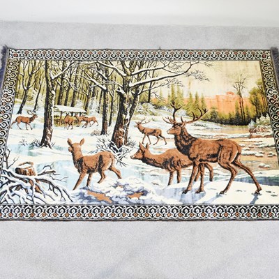 Lot 586 - A woollen tapestry, depicting deer in a snow,...