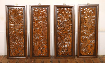 Lot 844 - A set of four Japanese carved wood wall panels,...