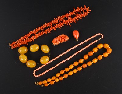 Lot 316 - A collection of strings of amber barrel beads...