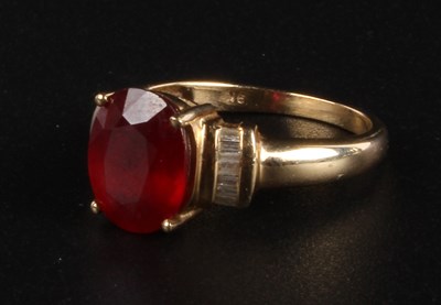 Lot 67 - A 9 carat ruby and diamond ring, the central...