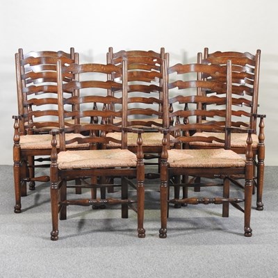 Lot 674 - A set of eight ladderback rush seated open armchairs