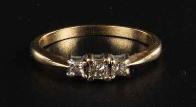 Lot 154 - A 9 carat yellow gold diamond three stone ring,...