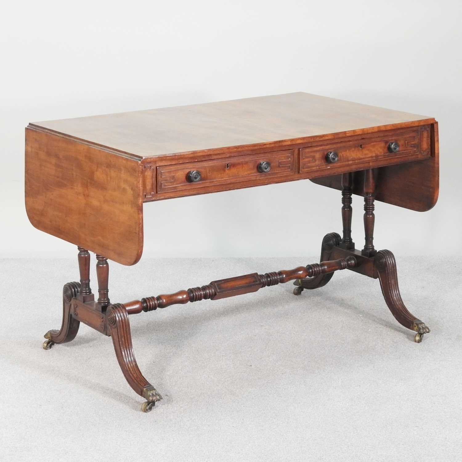 Lot 568 - A Regency mahogany sofa table, with a hinged...