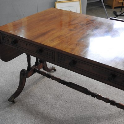 Lot 568 - A Regency mahogany sofa table, with a hinged...
