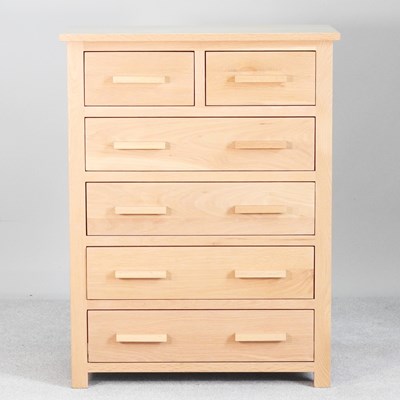 Lot 232 - A modern light oak chest of drawers