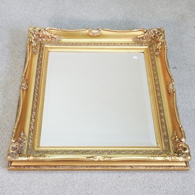 Lot 122 - A modern gilt framed wall mirror, with a swept...