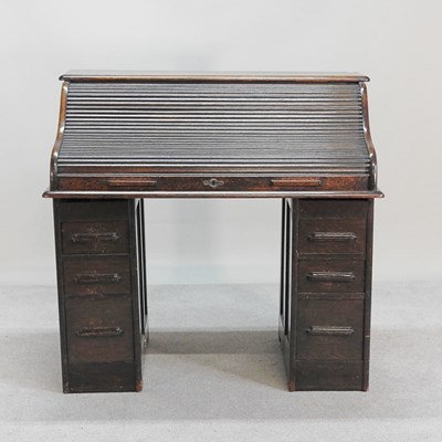 Lot 585 - An early 20th century oak tambour top pedestal...