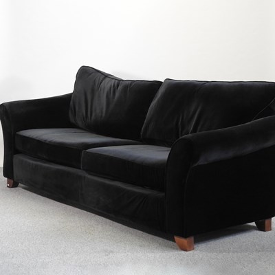 Lot 650 - A large modern black velvet sofa