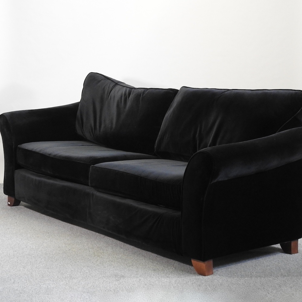 Lot 650 A large modern black velvet sofa