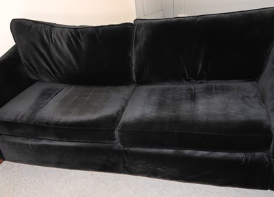 Lot 650 - A large modern black velvet sofa