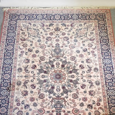 Lot 430 - A large Persian carpet on cream ground