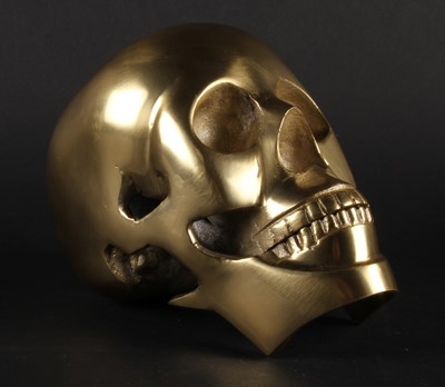 Lot 735 - A brass model of a skull