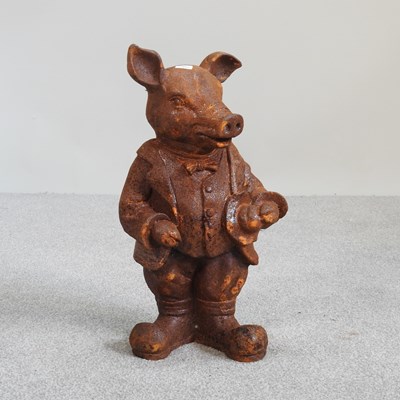 Lot 331 - A rusted metal garden statue of Mr Pig, 44cm high